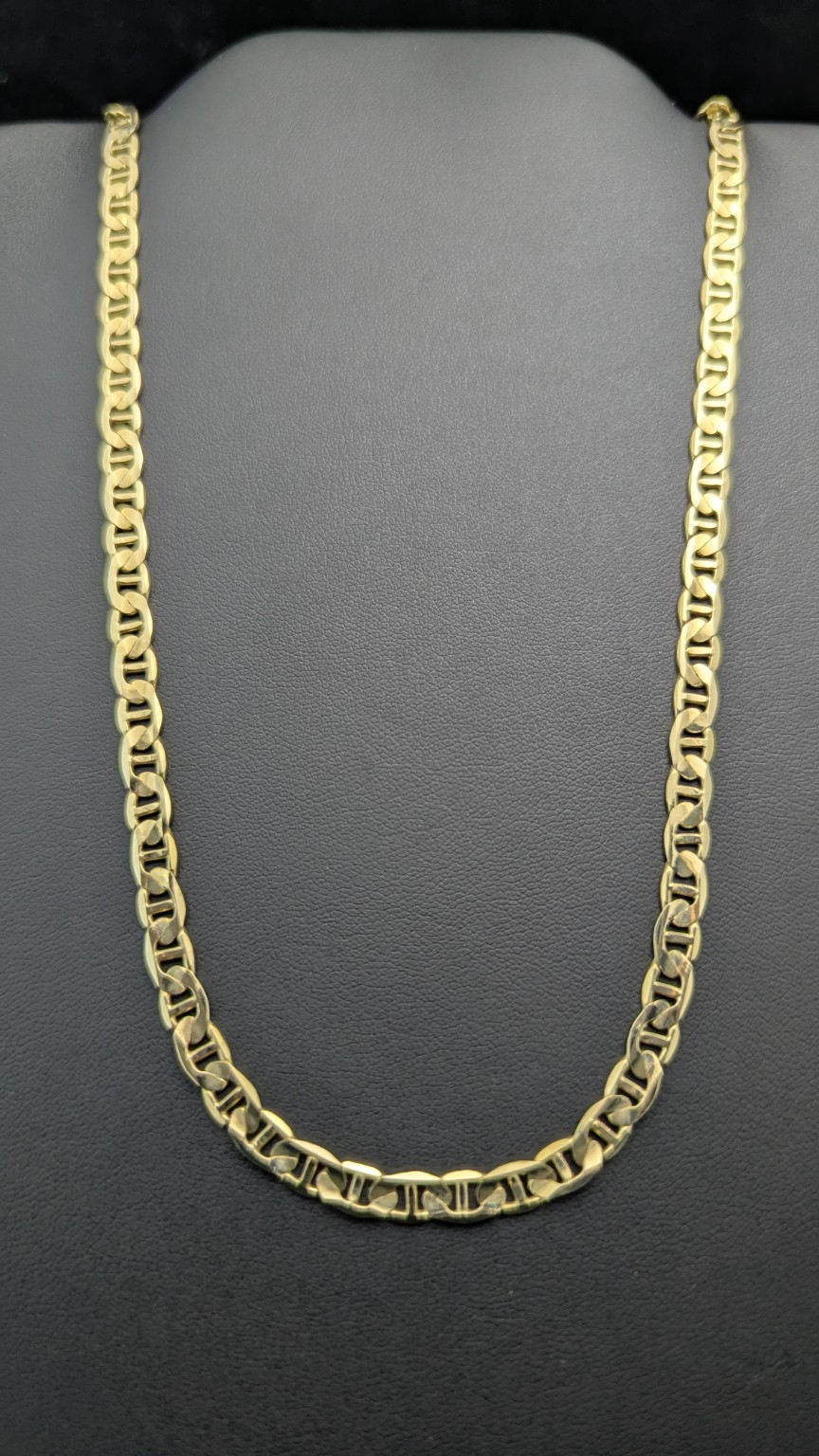 20-inch 14K yellow gold Gucci-link chain on a dark jewelry display