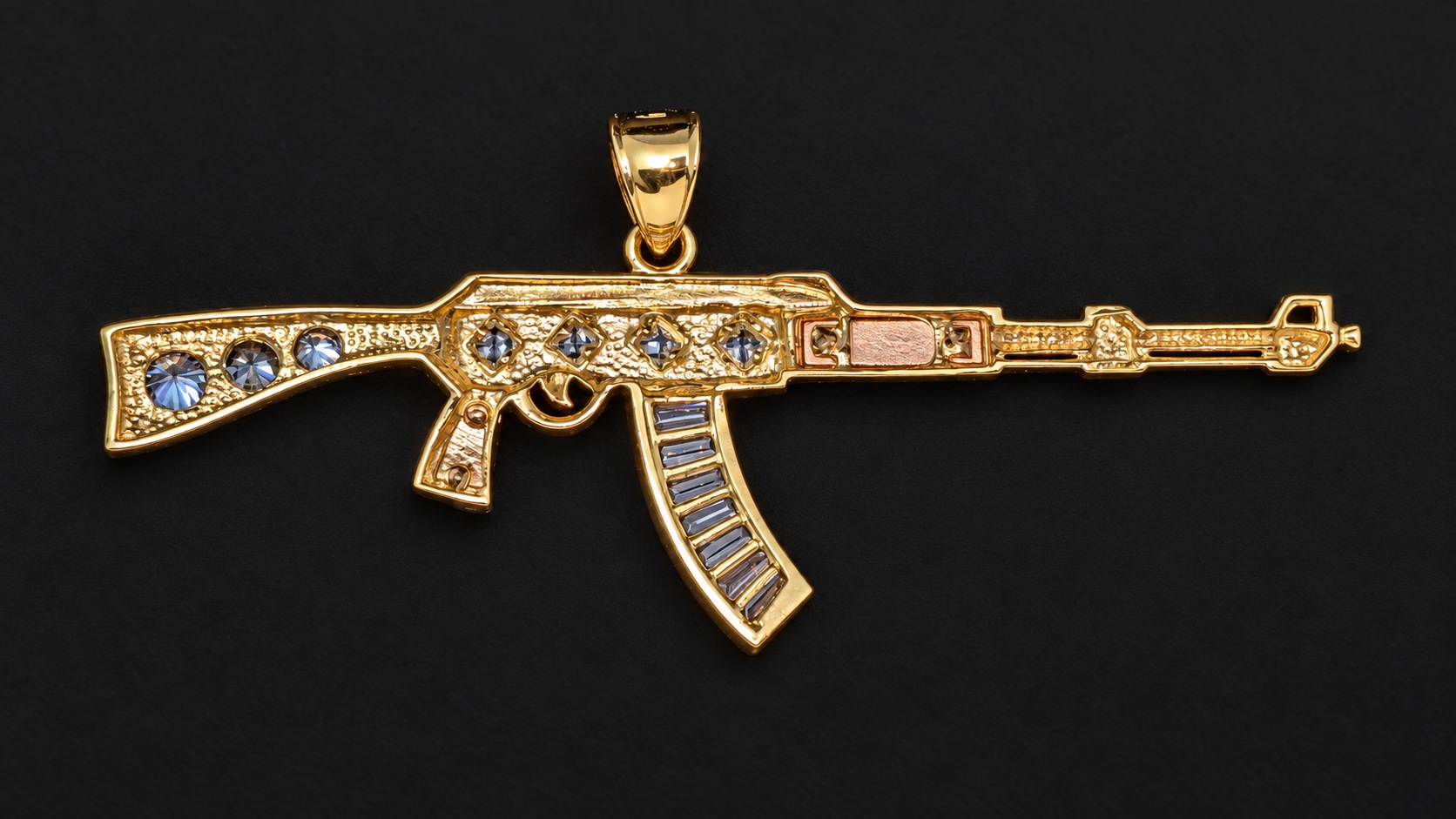 Back of 14K yellow gold AK-style pendant on a dark background